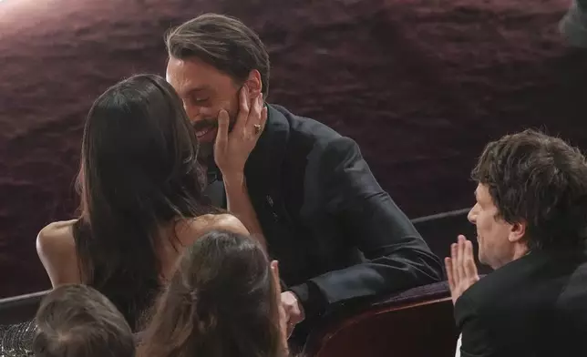 Jazz Charton, left, kisses Kieran Culkin as he wins the award for best performance by an actor in a supporting role for "A Real Pain" during the Oscars on Sunday, March 2, 2025, at the Dolby Theatre in Los Angeles. (AP Photo/Chris Pizzello)