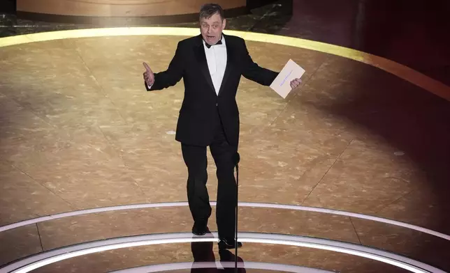 Mark Hamill presents the award for best original score during the Oscars on Sunday, March 2, 2025, at the Dolby Theatre in Los Angeles. (AP Photo/Chris Pizzello)