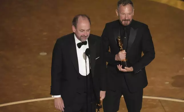 Nathan Crowley, left, and Lee Sandales accept the award for best production design for "Wicked" during the Oscars on Sunday, March 2, 2025, at the Dolby Theatre in Los Angeles. (AP Photo/Chris Pizzello)