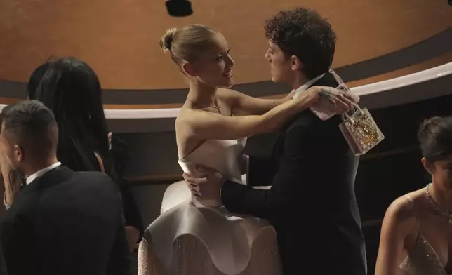 Ariana Grande, left, and Ethan Slater in the audience during the Oscars on Sunday, March 2, 2025, at the Dolby Theatre in Los Angeles. (AP Photo/Chris Pizzello)