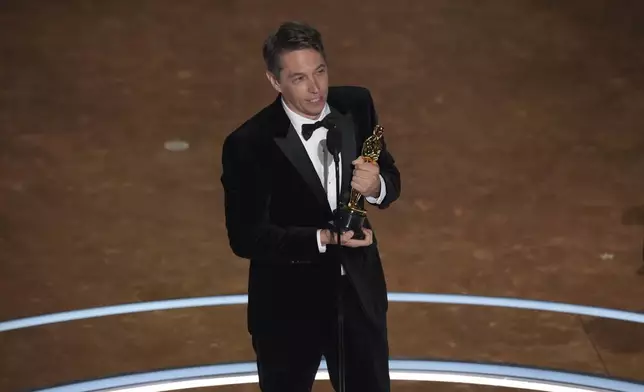 Sean Baker accepts the award for best original screenplay for "Anora" during the Oscars on Sunday, March 2, 2025, at the Dolby Theatre in Los Angeles. (AP Photo/Chris Pizzello)
