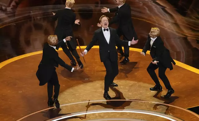Host Conan O'Brien, center, performs during the Oscars on Sunday, March 2, 2025, at the Dolby Theatre in Los Angeles. (AP Photo/Chris Pizzello)
