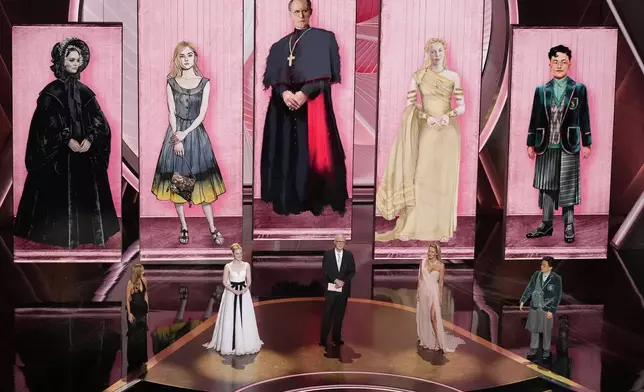 Lily-Rose Depp, from left, Elle Fanning, John Lithgow, Connie Nielsen and Bowen Yang presents the award for best costume design during the Oscars on Sunday, March 2, 2025, at the Dolby Theatre in Los Angeles. (AP Photo/Chris Pizzello)