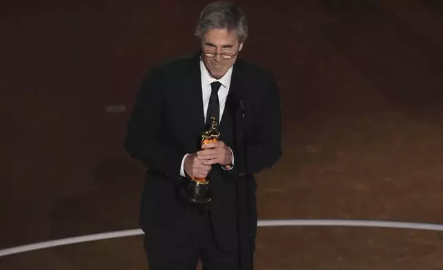 Walter Salles accepts the award for "I'm Still Here" from Brazil, for best international feature film during the Oscars on Sunday, March 2, 2025, at the Dolby Theatre in Los Angeles. (AP Photo/Chris Pizzello)