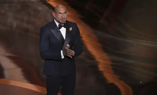 Dave Bautista presents the award for best cinematography during the Oscars on Sunday, March 2, 2025, at the Dolby Theatre in Los Angeles. (AP Photo/Chris Pizzello)