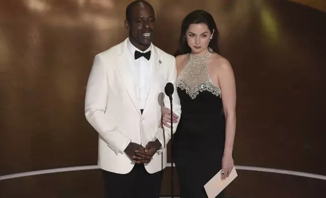 Sterling K. Brown, left, and Ana de Armas presents the award for best live action short film during the Oscars on Sunday, March 2, 2025, at the Dolby Theatre in Los Angeles. (AP Photo/Chris Pizzello)