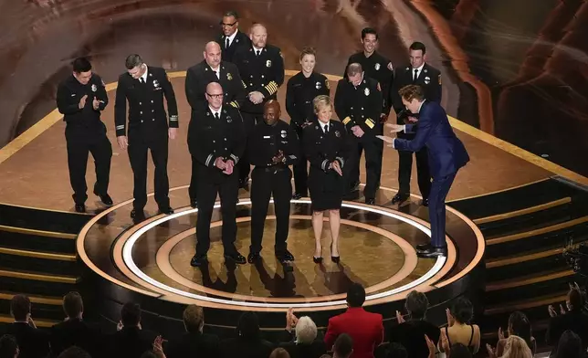 Members of the Los Angeles County Fire Department and Host Conan O'Brien, far right, on stage during the Oscars on Sunday, March 2, 2025, at the Dolby Theatre in Los Angeles. (AP Photo/Chris Pizzello)