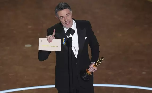 Peter Straughan accepts the award for best adapted screenplay for "Conclave" during the Oscars on Sunday, March 2, 2025, at the Dolby Theatre in Los Angeles. (AP Photo/Chris Pizzello)
