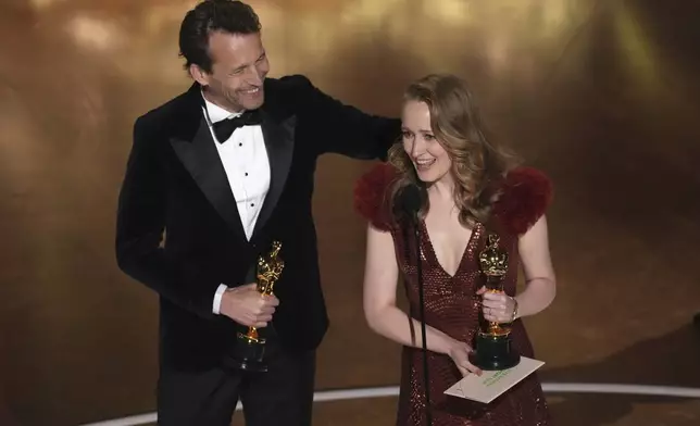 Trent, left, and Victoria Warmerdam accept the award for best live action short film for "I'm Not a Robot" during the Oscars on Sunday, March 2, 2025, at the Dolby Theatre in Los Angeles. (AP Photo/Chris Pizzello)
