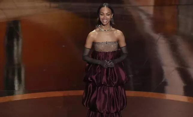 Zoe Saldana presents the award for best cinematography during the Oscars on Sunday, March 2, 2025, at the Dolby Theatre in Los Angeles. (AP Photo/Chris Pizzello)