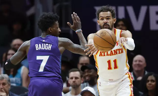 Atlanta Hawks guard Trae Young (11) passes against Charlotte Hornets guard Damion Baugh during the first half of an NBA basketball game in Charlotte, N.C., Tuesday, March 18, 2025. (AP Photo/Nell Redmond)