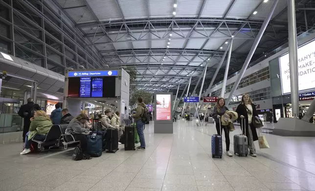 Only a few travelers are on the move in the departure area of the terminal building at Dusseldorf Airport, Germany Monday, March 10, 2025. (Christoph Reichwein/dpa via AP)
