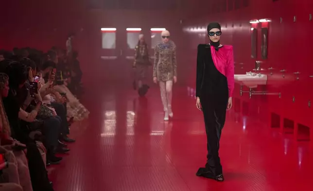 Models wear creations as part of the Valentino Fall/Winter 2025-2026 Womenswear collection presented in Paris, Sunday, March 9, 2025. (Photo by Scott A Garfitt/Invision/AP)