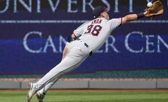 Cleveland Guardians left fielder Steven Kwan can't catch a double hit by Kansas City Royals' Kyle Isbel during the third inning of a baseball game against the Cleveland Guardians Thursday, March 27, 2025, in Kansas City, Mo. (AP Photo/Charlie Riedel)