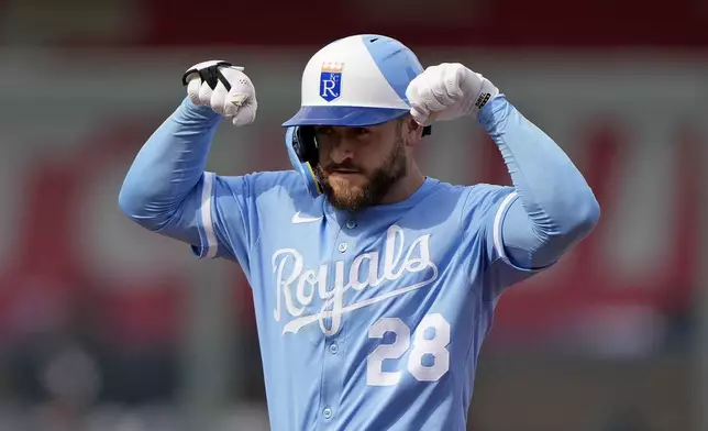Kansas City Royals' Kyle Isbel celebrates on second after hitting a double during the third inning of a baseball game against the Cleveland Guardians Thursday, March 27, 2025, in Kansas City, Mo. (AP Photo/Charlie Riedel)