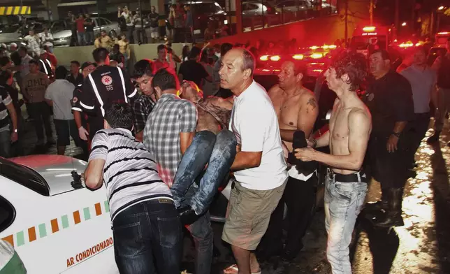 FILE - A victim of a fire in a club is carried in Santa Maria city, Rio Grande do Sul state, Brazil, early Sunday, Jan. 27, 2013. (AP Photo/Deivid Dutra/Agencia Freelancer, File)