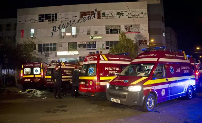 FILE - Ambulances are parked outside the site of a fire that occurred in a club, housed by the building in the background, in Bucharest, early Saturday, Oct. 31, 2015. (AP Photo/Vadim Ghirda, File)