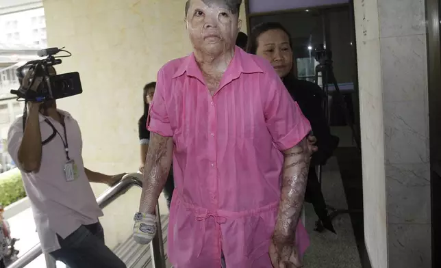 FILE -Victim of nightclub fire Rattana Saelim arrives at'the Bangkok Criminal Court in Bangkok, Thailand, on Tuesday, Sept. 20, 2011. (AP Photo/Sakchai Lalit, File)