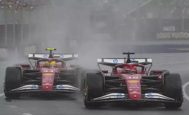 Ferrari driver Charles Leclerc, right, of Monaco and teammate Lewis Hamilton of Britain compete during the Australian Formula One Grand Prix at Albert Park, in Melbourne, Australia, Sunday, March 16, 2025. (AP Photo/Scott Barbour)