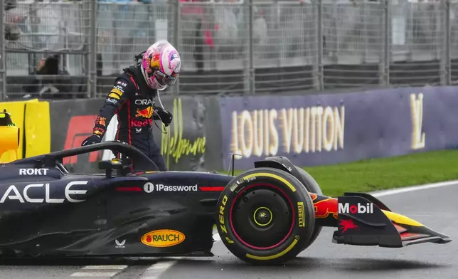Red Bull driver Liam Lawson of New Zealand stands by his car after crashing during the Australian Formula One Grand Prix at Albert Park, in Melbourne, Australia, Sunday, March 16, 2025. (AP Photo/Scott Barbour)