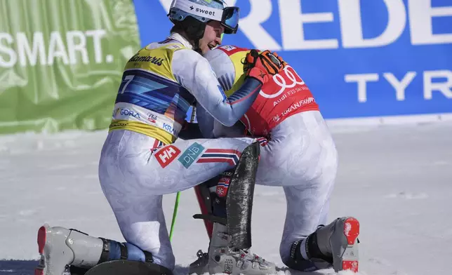 Norway's Henrik Kristoffersen, right, winner of an alpine ski, men's World Cup slalom, celebrates with second-placed Norway's Timon Haugan, in Kranjska Gora, Slovenia, Sunday, March 2, 2025. (AP Photo/Giovanni Auletta)