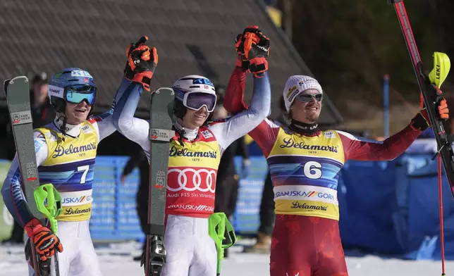 Norway's Henrik Kristoffersen, center, winner of an alpine ski, men's World Cup slalom, celebrates with second-placed Norway's Timon Haugan, left, and third-placed Austria's Manuel Feller, in Kranjska Gora, Slovenia, Sunday, March 2, 2025. (AP Photo/Giovanni Auletta)