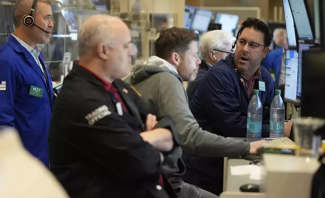 People work on the options floor at the New York Stock Exchange in New York, Wednesday, March 19, 2025. (AP Photo/Seth Wenig)