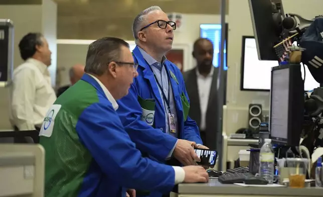 People work on the options floor at the New York Stock Exchange in New York, Wednesday, March 19, 2025. (AP Photo/Seth Wenig)