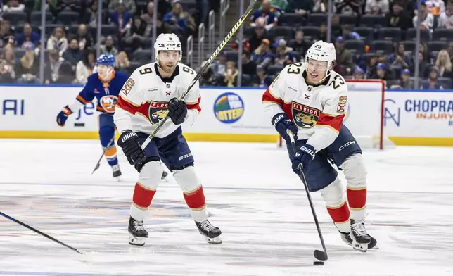 Florida Panthers center Carter Verhaeghe (23) controls the puck during the first period of an NHL hockey game against the New York Islanders, Sunday, March 16, 2025, in Elmont, N.Y. (AP Photo/Stefan Jeremiah)