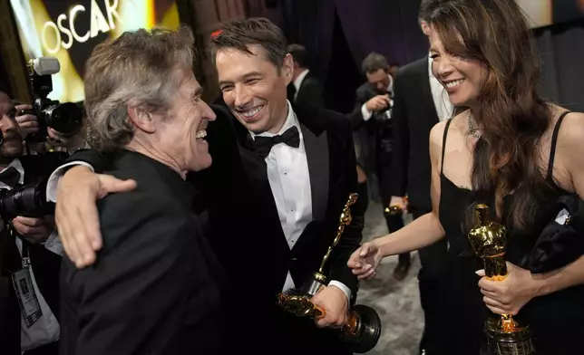 Willem Dafoe, from left, Sean Baker, winner of the awards for best original screenplay, best film editing, best director, and best picture for "Anora," and Samantha Quan, winner of the award for best picture for "Anora," attend the Governors Ball after the Oscars on Sunday, March 2, 2025, in Los Angeles. (AP Photo/John Locher)