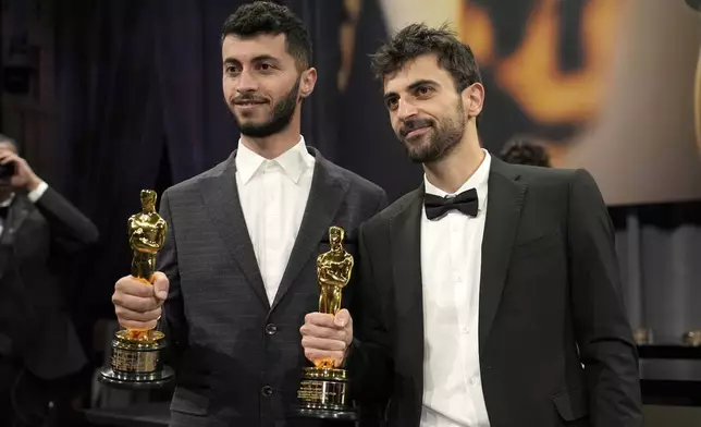 Basel Adra, left, and Yuval Abraham, winners of the award for best documentary feature film for "No Other Land," the Governors Ball after the Oscars on Sunday, March 2, 2025, in Los Angeles. (AP Photo/John Locher)
