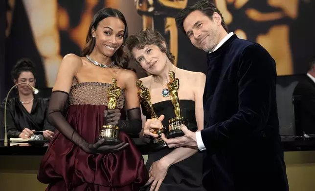 Zoe Saldana, left, winner of the award for best performance by an actress in a supporting role for "Emilia Perez," Camille and Clement Ducol, winners of the award for best original song for "El Mal" from "Emilia Perez," attend the Governors Ball after the Oscars on Sunday, March 2, 2025, in Los Angeles. (AP Photo/John Locher)