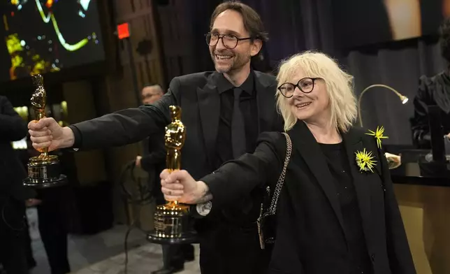 Pierre-Olivier Persin, left, and Stephanie Guillon, winners of the award for best makeup and hairstyling for "The Substance," attend the Governors Ball after the Oscars on Sunday, March 2, 2025, in Los Angeles. (AP Photo/John Locher)