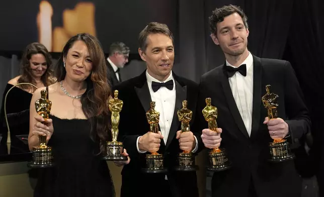 Samantha Quan, from left, winner of the award for best picture for "Anora, Sean Baker, winner of the awards for best original screenplay, best film editing, best director, and best picture for "Anora," and Alex Coco, winner of the award for best picture for "Anora," attend the Governors Ball after the Oscars on Sunday, March 2, 2025, in Los Angeles. (AP Photo/John Locher)