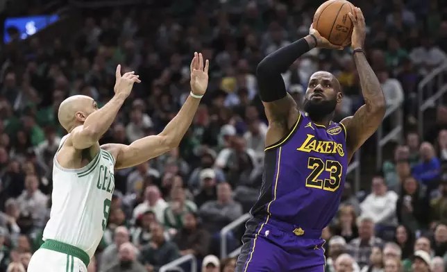 Los Angeles Lakers forward LeBron James (23) makes an outside shot over Boston Celtics guard Derrick White (9) during the first half of an NBA basketball game, Saturday, March 8, 2025, in Boston. (AP Photo/Mark Stockwell)