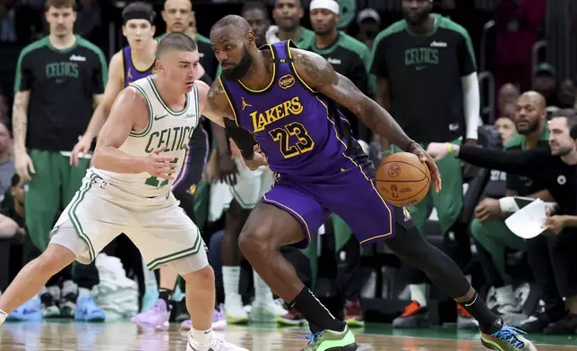 Los Angeles Lakers forward LeBron James (23) defends the ball from Boston Celtics guard Payton Pritchard, left, during the second half of an NBA basketball game, Saturday, March 8, 2025, in Boston. (AP Photo/Mark Stockwell)
