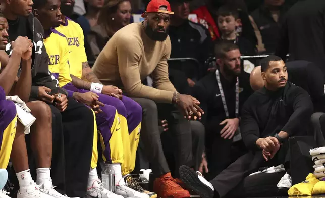 Los Angeles Lakers' LeBron James, center, sits on the bench during the second half of an NBA basketball game against the Brooklyn Nets, Monday, March 10, 2025, in New York. (AP Photo/Pamela Smith)