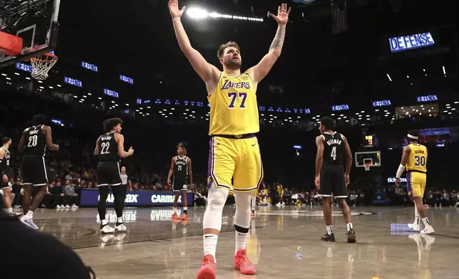 Los Angeles Lakers' Luka Doncic (77) reacts after a foul was called on the Brooklyn Nets during the second half of an NBA basketball game Monday, March 10, 2025, in New York. (AP Photo/Pamela Smith)