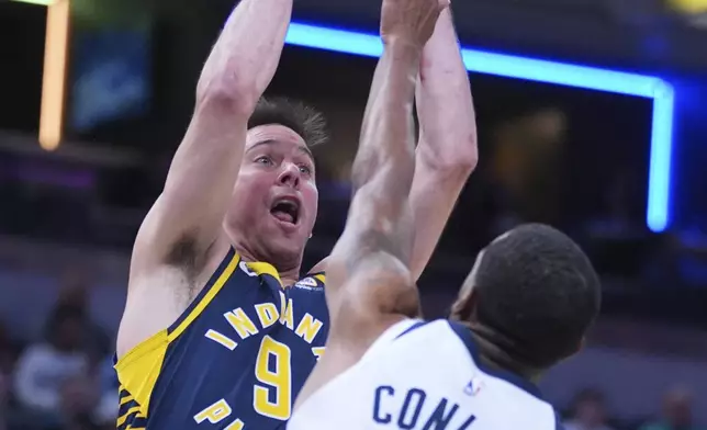 Indiana Pacers guard T.J. McConnell (9) shoots over Minnesota Timberwolves guard Mike Conley (10) during the first half of an NBA basketball game in Indianapolis, Monday, March 24, 2025. (AP Photo/Michael Conroy)