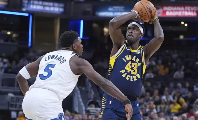 Indiana Pacers forward Pascal Siakam (43) shoots over Minnesota Timberwolves guard Anthony Edwards (5) during the first half of an NBA basketball game in Indianapolis, Monday, March 24, 2025. (AP Photo/Michael Conroy)