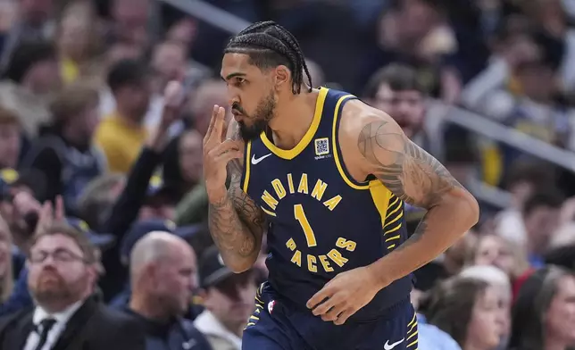 Indiana Pacers forward Obi Toppin (1) gestures after a three-point basket against the Minnesota Timberwolves during the second half of an NBA basketball game in Indianapolis, Monday, March 24, 2025. (AP Photo/Michael Conroy)