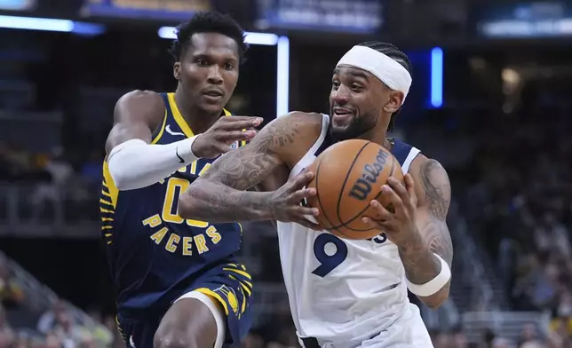 Minnesota Timberwolves guard Nickeil Alexander-Walker (9) drives on during the second half of an NBA basketball game in Indianapolis, Monday, March 24, 2025. (AP Photo/Michael Conroy)