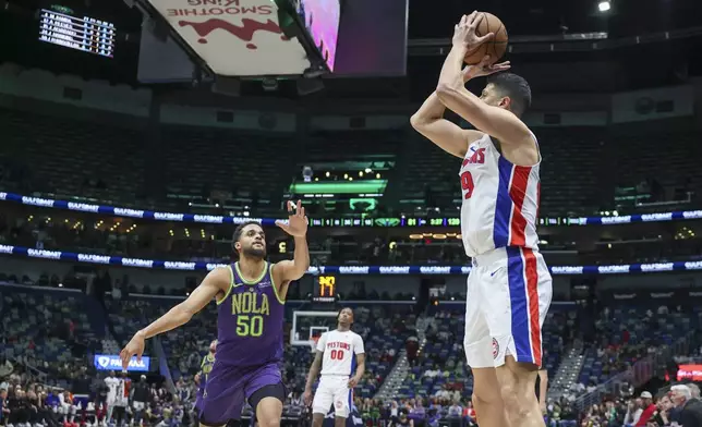 Detroit Pistons forward Simone Fontecchio (19) shoots a 3-pointer over New Orleans Pelicans forward Jeremiah Robinson-Earl (50) in the second half of an NBA basketball game in New Orleans, Monday, March 17, 2025. (AP Photo/Peter Forest)