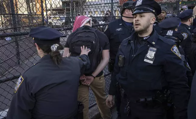 New York Police Department officers detain a protester during a demonstration in support of Palestinian activist Mahmoud Khalil, Monday, March 10, 2025, in New York. (AP Photo/Yuki Iwamura)