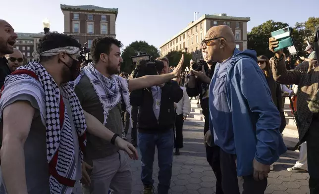 FILE - Pro-Palestinian demonstrator Mahmoud Khalil, second from left, debates with a pro-Israel demonstrator during a protest at Columbia University, Thursday, Oct. 12, 2023, in New York. (AP Photo/Yuki Iwamura, File)