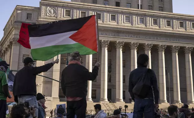 Protesters hold Palestinian flag during a demonstration outside Manhattan Federal Court in support of Palestinian activist Mahmoud Khalil, Monday, March 10, 2025, in New York. (AP Photo/Yuki Iwamura)