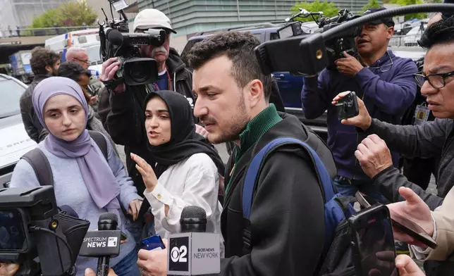 FILE - Members of the Columbia University Apartheid Divest group, including Sueda Polat, second from left, and Mahmoud Khalil, center, are surrounded by members of the media outside the Columbia University campus, Tuesday, April 30, 2024, in New York. (AP Photo/Mary Altaffer, File)