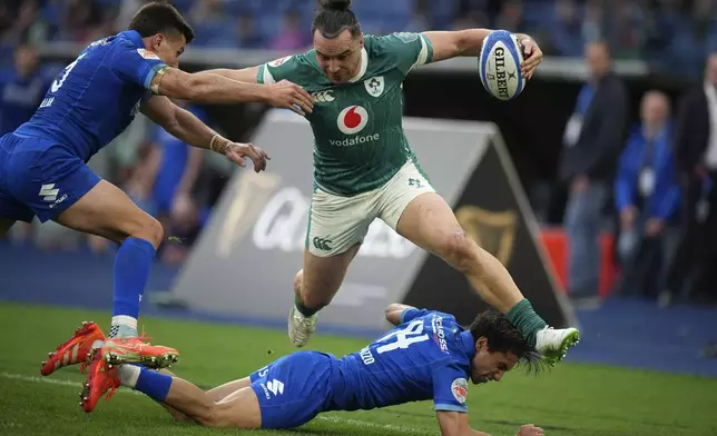 Ireland's James Lowe, jumps over Italy's Ange Capuozzo during the Six Nations rugby match between Italy and Ireland, at Rome's Olympic Stadium, Saturday, March 15, 2025. (AP Photo/Andrew Medichini)