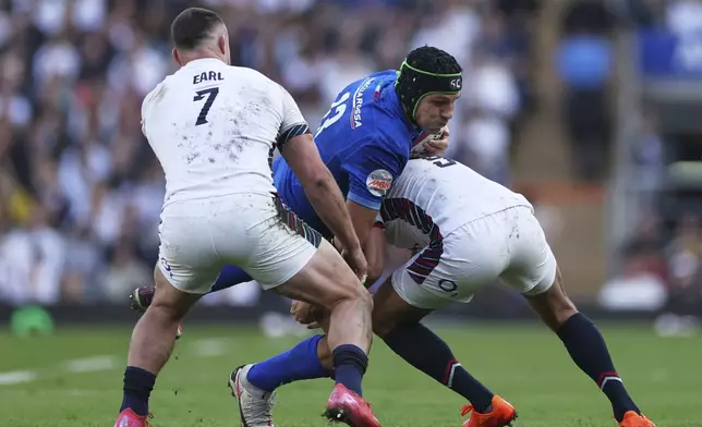 Italy's Juan Ignacio Brex, is tackled by England's Alex Mitchell, right and England's Ben Earl during the Six Nations rugby match between England and Italy at Twickenham stadium in London, Sunday, March 9, 2025. (AP Photo/Ian Walton)
