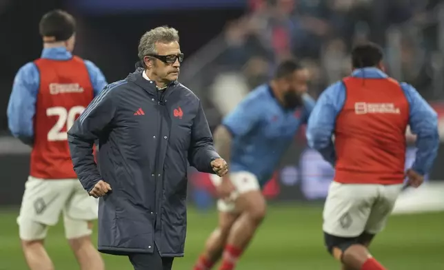 France's coach Fabien Galthie watches as he team warm-up before the Six Nations rugby union match between France and Scotland at the Stade de France in Saint-Denis, outside Paris, Saturday, March 15, 2025. (AP Photo/Christophe Ena)